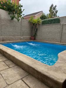 a small blue swimming pool next to a fence at Casa Fuerteventura in Santiago