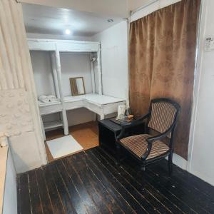 a room with a chair and a desk and a mirror at Coral Reef Holidays in Tioman Island