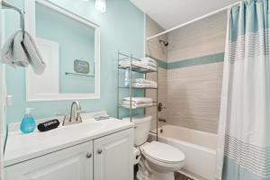 Un baño con lavabo, inodoro y ducha. en Come Sail Away, en Destin 43 fotos más