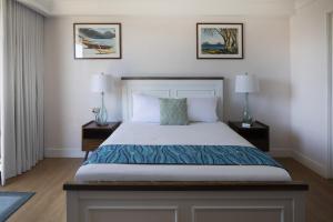 a bedroom with a large bed with two night stands at Refreshing Royal Garden Studio condo in Honolulu