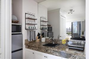 a kitchen with a sink and a counter top at Refreshing Royal Garden Studio condo in Honolulu