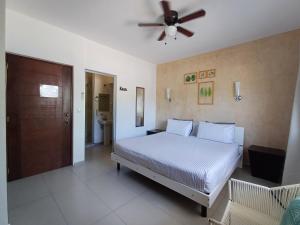 a bedroom with a bed and a ceiling fan at Casa Linda Isla-Room Palmera-Shared Pool in Isla Mujeres +11 photos