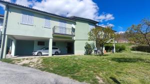 a house with a car parked in front of it at Casa Braida in Muro Lucano