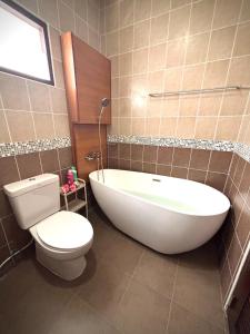 a bathroom with a white tub and a toilet at Unjai watket in Ban Nong Chaeng +19 photos