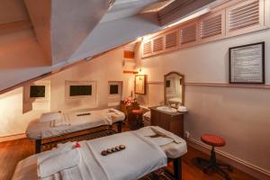 a hospital room with two beds and a sink at Dalat Palace Heritage Hotel in Da Lat