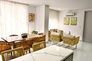 a dining room with a table and chairs at Azure apartahotel in Santa Marta