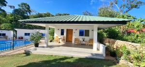 a small house with a porch with a roof at Casa Feliz Ocean Resort in Siquijor