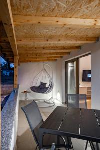 a dining room with a table and chairs at Grgurić Apartments in Rab