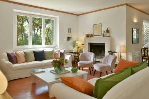 a living room with a couch and a table at Seaside Villa In Marina Di Bibbona Pine Forest in Marina di Bibbona