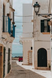 eine Straße in Positano mit einer schwarzen Tür und dem Meer in der Unterkunft La casa di Cò trilocale Centro storico Gallipoli in Gallipoli