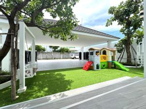 a backyard with a play yard with a playground at The White House Pool Villa Pattaya in Jomtien Beach