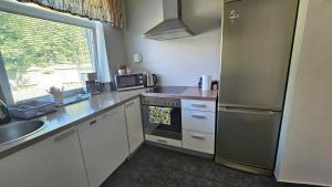 a kitchen with a stainless steel refrigerator and a sink at Unique & Spacious 2 Bedroom Apartment with Sauna in Pärnu