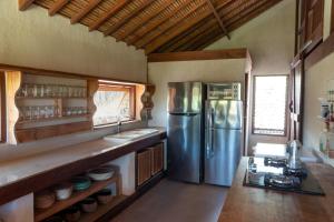 a kitchen with a large stainless steel refrigerator at Rote Beach House in Nembrala