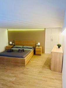 a bedroom with a large bed and two night stands at Holiday House Valpiè in Avola