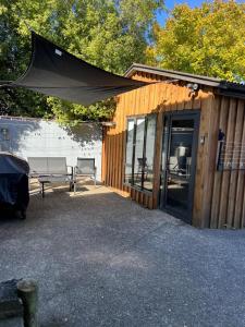 a building with a tent and a bench next to it at Self-contained Tiny Sleepout in Hamner in Hanmer Springs