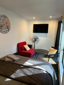 a room with a bed and a chair and a table at Self-contained Tiny Sleepout in Hamner in Hanmer Springs