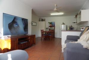 a living room with a large flat screen tv at Bongaree Getaway in Bongaree