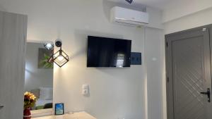 a room with a television on the wall at Harmony Studios & Apartments in Skala Potamias
