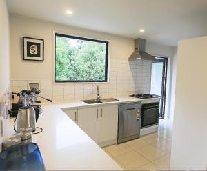 a kitchen with a sink and a window at Stunning Mountain Views in Renovated Hamner Home in Hanmer Springs