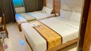 Dos camas en una habitación de hotel con en Hotel RR inn-International Airport, en Bombay