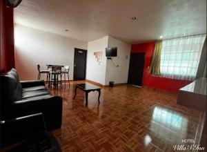a living room with a couch and a table at Hotel Villas Inn in Sofía