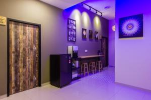 a bar in a restaurant with purple lighting at Newly 4BR Cottage House Retreats with Free Parking in Butterworth