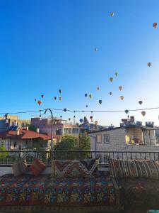 a bunch of hot air balloons flying over a city at Leo's Cappadocia in Goreme