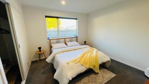 a bedroom with a bed and a window at Private room in homestay in Ashhurst
