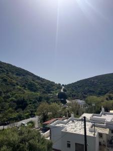 a view of a city with hills in the background at Kalliopis view , Kinidaros in Kinídharos +5 photos