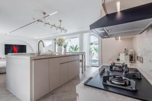 a kitchen with a sink and a stove top oven at Brand new Luxury 2 BR Villa CASA COCO LAUBANA in Uluwatu