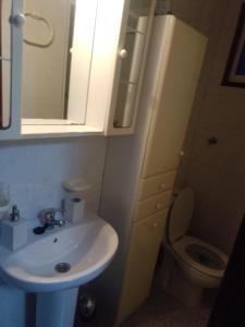 a bathroom with a sink and a toilet and a mirror at Lage ,Costa da Morte, ruta dos faros, Galicia, playa in Laxe