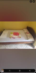 a bed with two pillows on it in a room at Robeck's Guest House in Gatunga