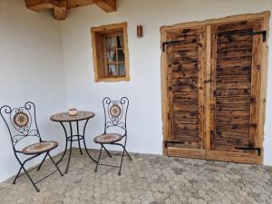 a table and chairs in a room with a door at Izba in Lendava