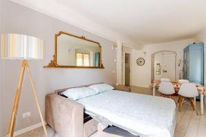 a bedroom with a bed and a mirror on the wall at Casa Margherita dal Bacchetto in Varazze