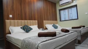 two beds in a hotel room with at Arcadia Homestay in Kāsarkod