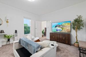a living room with a white couch and a flat screen tv at 475 Unit 3 Stunning Private 1B unit Kingsize bed &sofa bed AC in San Jose