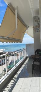 a balcony with a view of the ocean at Umbrella Apartment in Perea +13 photos