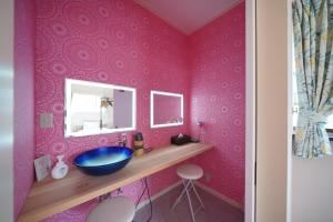 a pink bathroom with a sink and a mirror at kawana To the Beach in Ito +40 photos