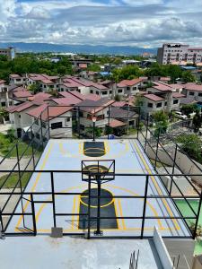 a basketball court with a basketball hoop in a city at Raph Staycation near Mactan Newtown in Lapu Lapu City