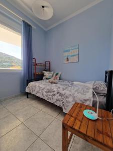 a bedroom with a bed and a wooden table at Emporios Mansion in Emporeiós