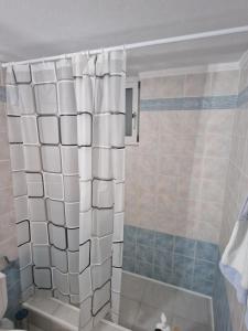 a bathroom with a shower with white tiles at Emporios Mansion in Emporeiós