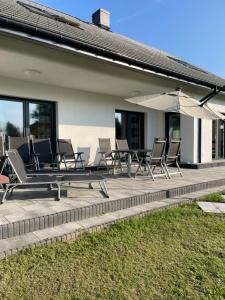 a group of chairs and an umbrella on a patio at Villa WoW in Zastań