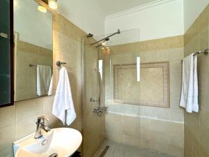 a bathroom with a sink and a shower at Villa Yianna in Karavádhos +38 photos