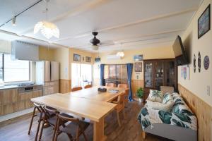 a kitchen and dining room with a table and a couch at kawana To the Beach in Ito