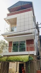 a man standing in front of a tall building at Chandra in Bengaluru