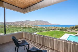 a balcony with chairs and a view of the ocean at Nusa Retreat - Seaview luxury residences in Kissamos