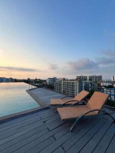 two chairs on the deck of a building overlooking the water at D Eco Wellness Center in North Pattaya +92 photos