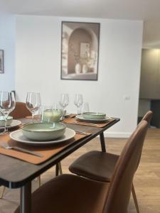 a wooden table with plates and wine glasses on it at City Studio in Tulcea +4 photos