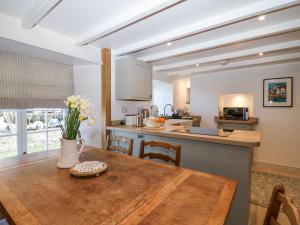 a kitchen and dining room with a wooden table at Harbour View in Looe