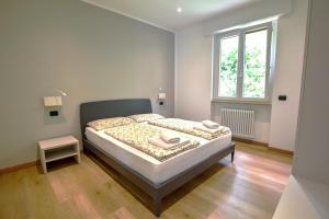 a bedroom with a bed and a window at Casa Manu in Brenzone sul Garda